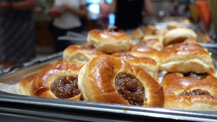 Restaurant Buffet. In the foreground buns with jam.