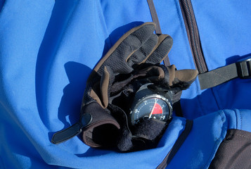 gloves for the parachute sport with an altimeter lie on the background of a blue bag