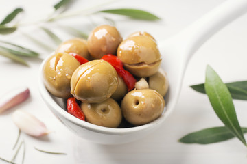 Olives on white spoon. Alorena olive. Typical spanish appetizer.