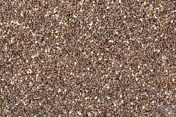 Chia seeds background. Close up chia seeds texture as superfood, organic and healthy food concept. Chia seeds top view background.