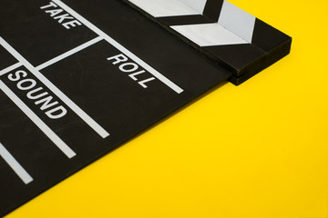 Movie clapper on a yellow background