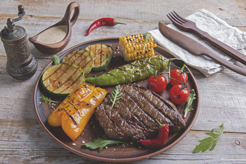 beef steak with grilled vegetables on the plate