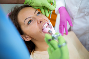 Dentist check up and repair tooth of young girl,injection