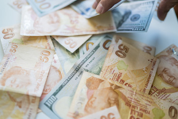 money background with american dollars and turkish liras, hundred dollars and fifty turkish liras background. random moneys, economic and financial crisis