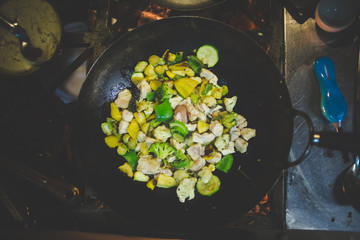 Close up image of a chef preparing a gourmet dish in a rustic restaurant kitchen