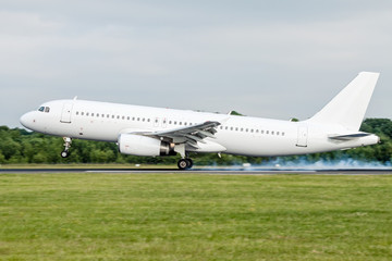 Fototapeta na wymiar White aircraft landing at Manchester International Airport