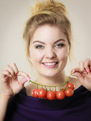 Woman holding fresh cherry tomatoes