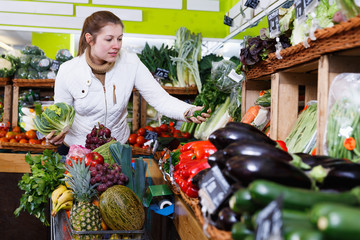 Woman in store of fruits and vegetables