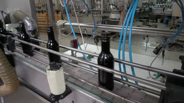 Bottling and sealing conveyor line at winery factory