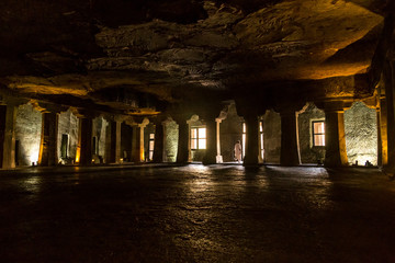 Inside of Buddhist monastery Ajanta Caves in Aurangabad, Maharashtra, India. A prayer leaving the monastery.