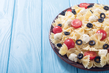 Pasta salad with mozzarella , olives and tomatoes