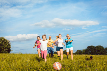 Family playing, running and doing sport in summer landscape