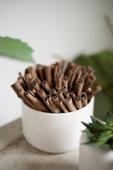A bundle of cinnamon placed in a holder for an aromatherapy and decoration