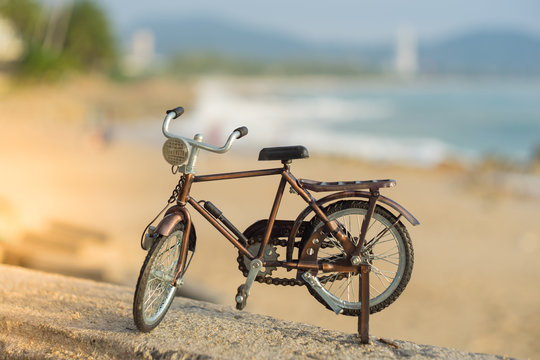 bicycle transport toy on sand sea beach in the evening sunset sky