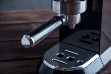Preparation of espresso. Black coffee machine on the table. Professional coffee brewing