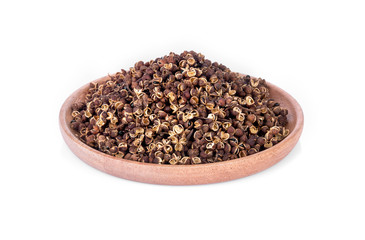 Dry Zanthozylum limonella Alston in wooden bowl on white background.