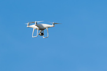 Fototapeta na wymiar Drone quadcopter with digital camera, Drone hovering in blue sky