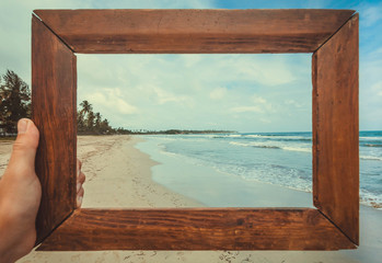 Ocean beach landscape in photoframe for memory. Tropical climate nature and fantastic view on calm blue waves of Sri Lanka or India