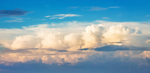 Blue sky with curly clouds during the sunset. Panorama_