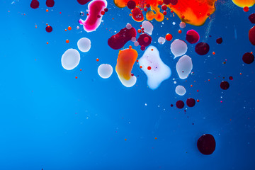 Red bubbles of blood cells on blue background. Abstraction of medicine. Micro processes and diseases