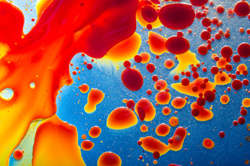 Red bubbles of blood cells on blue background closeup. Abstraction of medicine. Concept of micro...