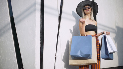 Portrait of an attractive smiling young woman in a hat. Stylish fashionably dressed