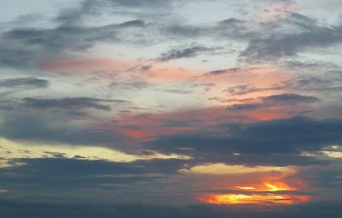 Colorful sunset with black dramatic clouds in the sky, natural background