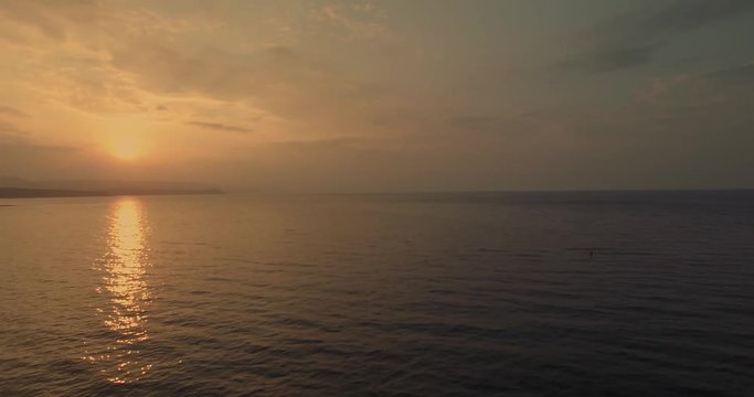 Sunset over Brown bay, Ireland as fishing boats return to shore