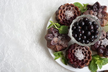 muffin and currant berries on white background