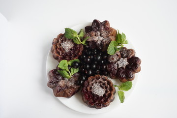 muffin and currant berries on white background