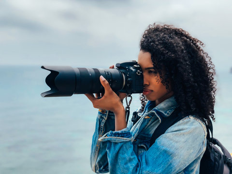 Photographer taking a picture of a ocean coast