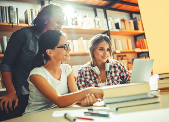 Group of female students read and learns at the campus library.Preparing for test.