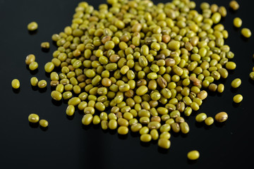dry beans, mung beans, on a black background