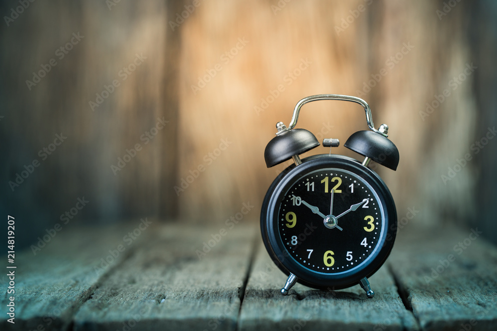 Wall mural Alarm clock on wood