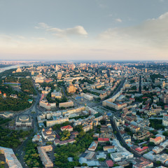 Obraz premium Panorama of the city of Kiev at sunset. A modern metropolis in the center of Europe against the backdrop of sunset sky from a bird's eye view. Aerial view. Panorama of the Tourist Center of Kiev.