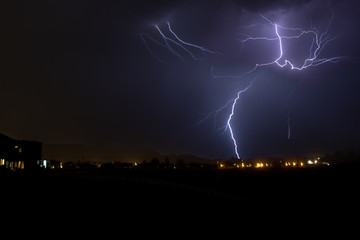 Lightning strikes during a thunderstorm in an urban area