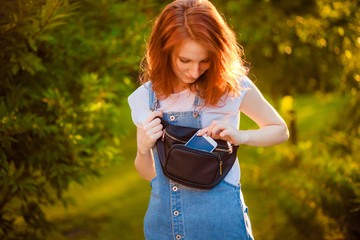 Red-haired girl with waist bag