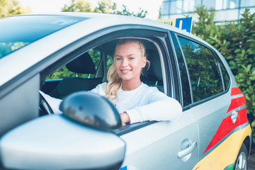 Girl sitting in a car driving school