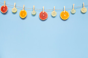 Slices of orange, grapefruit, lemon and lime hanging on a rope