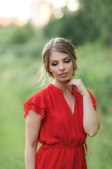 Beautiful young happy girl in the blossoming fields, thinking about her life and goals. Slow life, minimalism, mindfulness