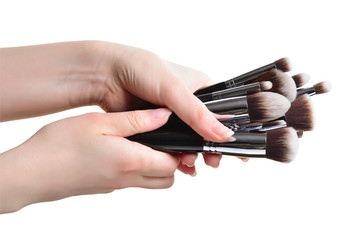 Professional make-up brushes cosmetic in female hand beautician isolated on white background
