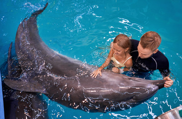 child swims with a Dolphin
