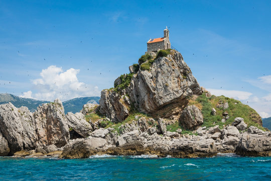 View of beautiful islets Katic (Katich) and Sveta Nedjelja with church on one of them in the sea near Petrovac, Montenegro.