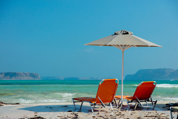 View at parasol and sunbeds at sea lagoon of Balos, Greece in summertime season, July