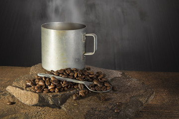 Coffee beans  with spoon and old aluminium cup
