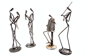 Creative figures of musicians, violinist and accordionist are playing for couple who dancing tango...