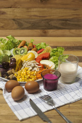 Salads ,eggs and milk placed on wooden table