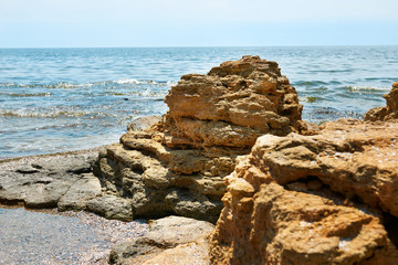 Fototapeta na wymiar stones on the beach, beautiful sea summer landscape, wild beach closeup