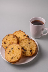 Sweet cake and tea on gray background.