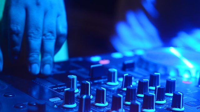 Hand Dj mixing Control Music in club party.